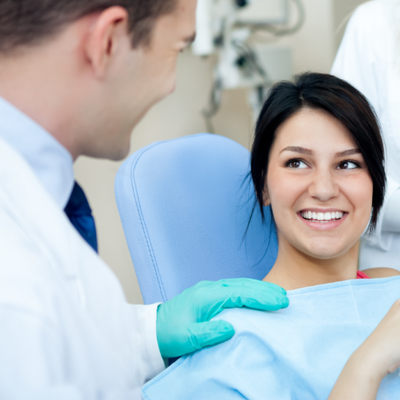 Woman smiling at her orthodontist during treatment visit