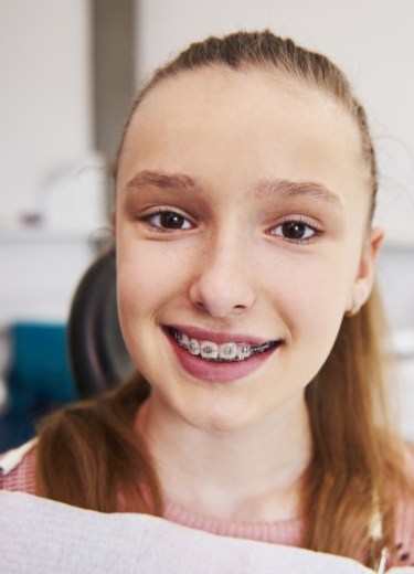 Teen with traditional braces smiling