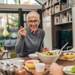 Woman smiling while eating meal with friend