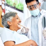 Dentist showing patient reflection in mirror