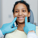 Orthodontist looking at teen's smile