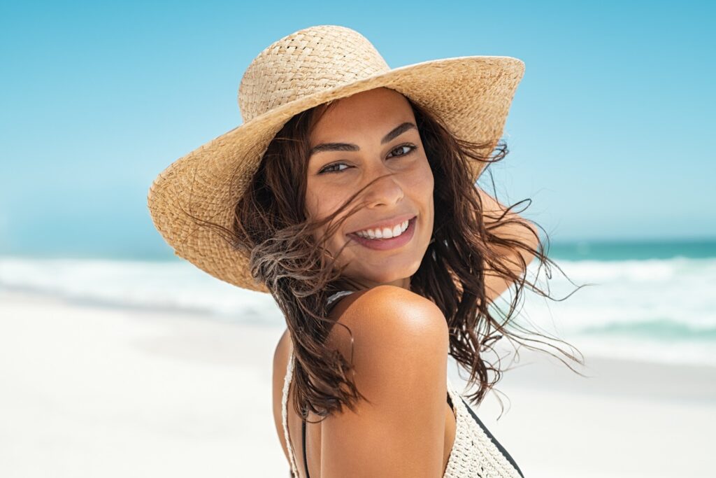 Woman smiling while walking on beach