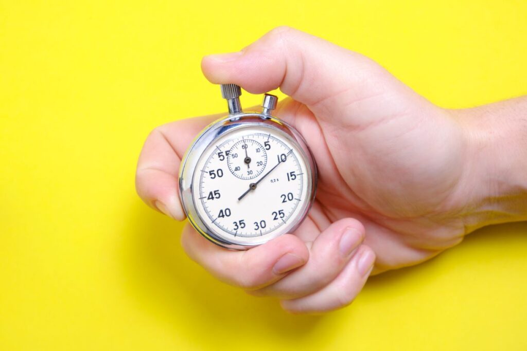 A hand holding a timer